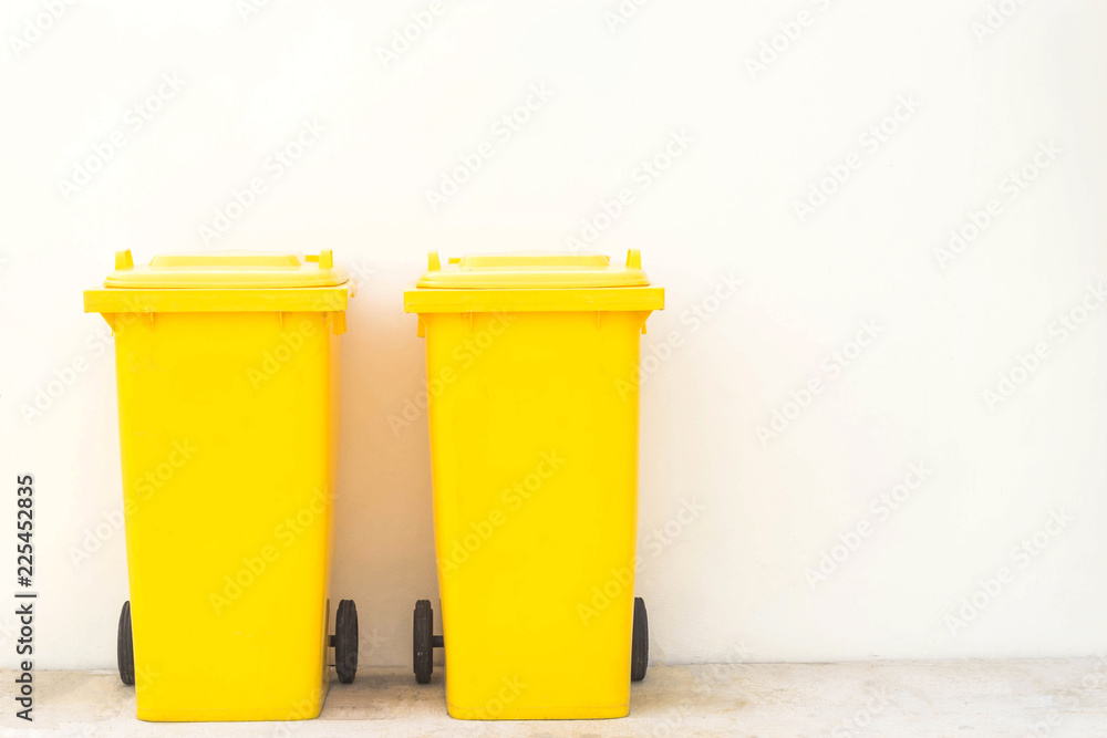 Yellow bins in the park / Wheeled garbage cans on the street. Yellow bins in the park / Wheeled garbage cans on the street.