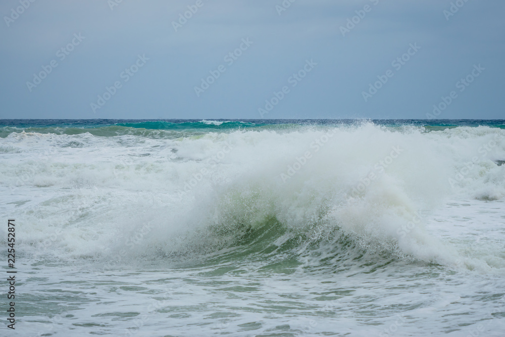 Rough sea wave on the rocky Coast of Gozo Marsalforn. Horizontal Space for text.