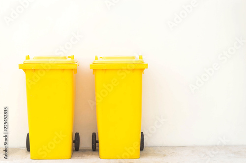 Yellow bins in the park / Wheeled garbage cans on the street.