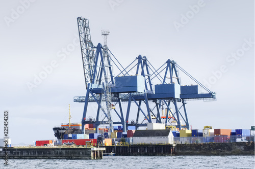 Container terminal crane gantry for loading and offloading cargo freight shipping at quay yard harbour dock on sea coast Greenock Scotland UK