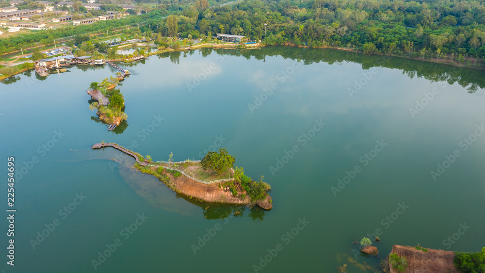 Fototapeta premium aerial top view walking bridge in the river on island in the park