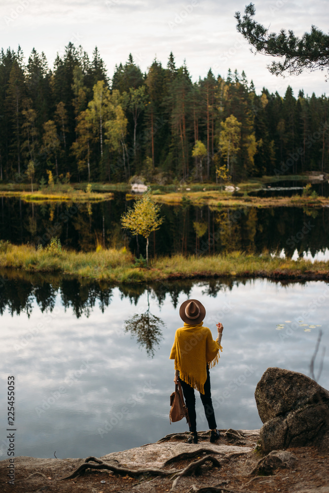 Young woman with hat at national park near lake