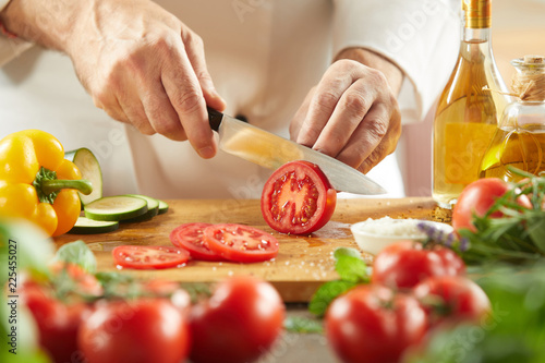 Fototapeta Naklejka Na Ścianę i Meble -  Chef preparing a fresh Italian salad