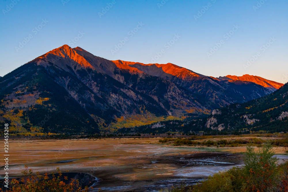Sunrise in the Colorado Mountains Showing Bright Sunlight Shining on Mountain Tops