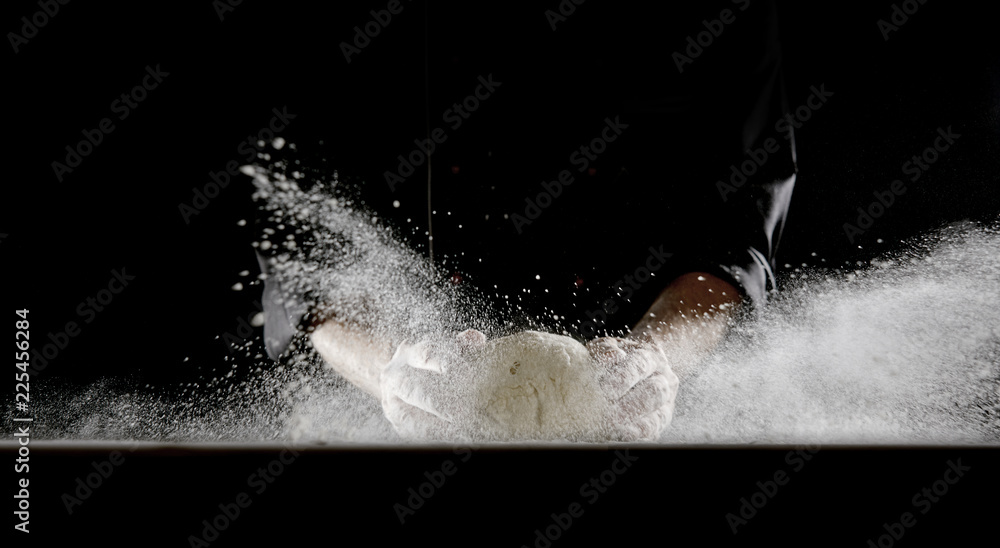 Obraz premium Frontal view of man dropping dough onto table