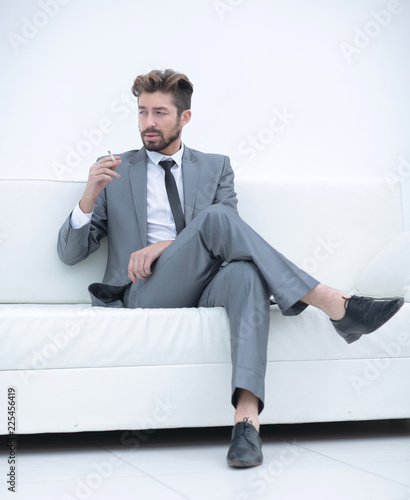 Portrait of a businessman in a suit with a cigarette © ASDF