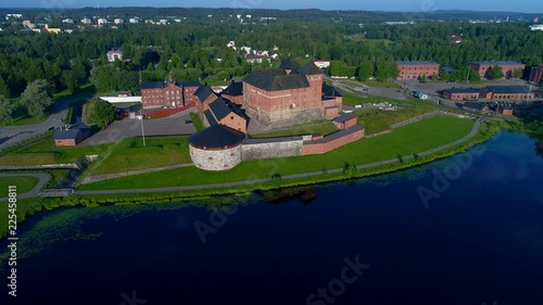 Fortress Hameenlinna on the lake Vanajavesi, July morning. Finland (aerial video)  photo