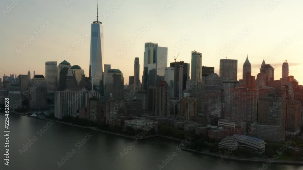 wider dawn sun peeks through as camera flies north along westside of downtown Manhattan wider dawn sun peeks through as camera flies north along westside of downtown Manhattan
