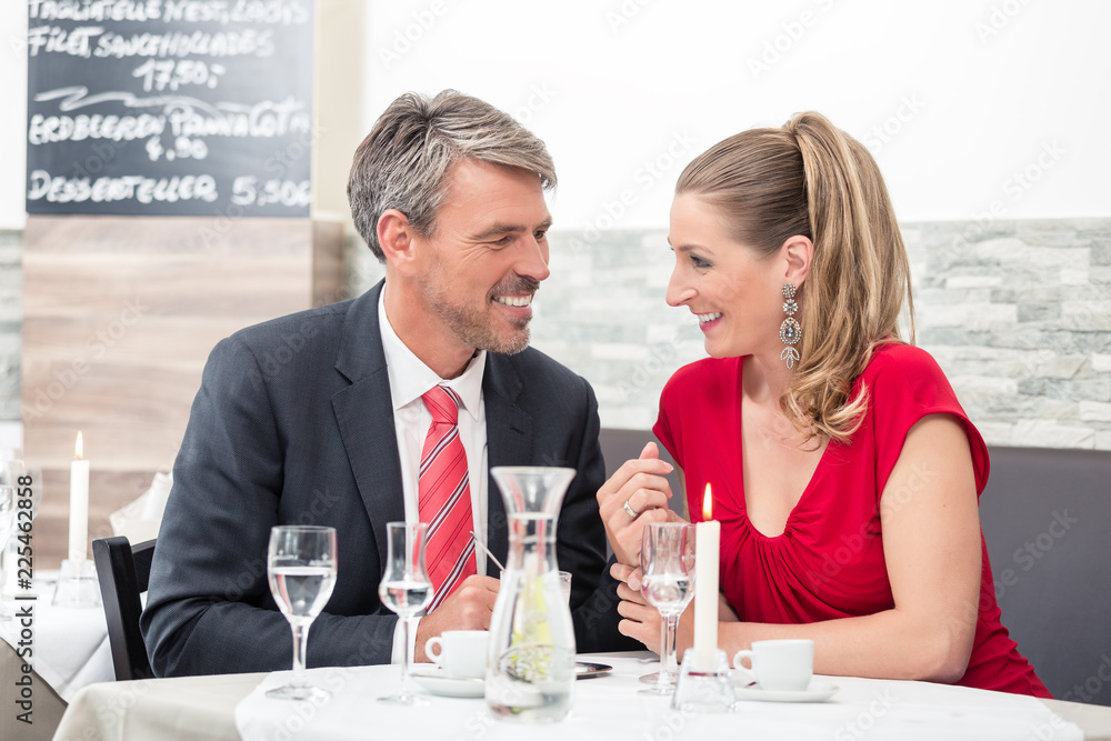 Happy couple on candle light date in restaurant Happy couple on candle light date in restaurant