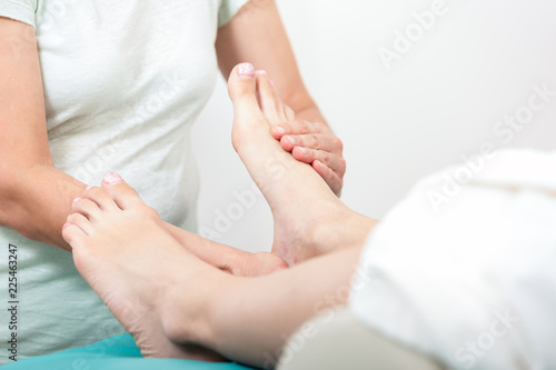 Close-up of a woman receiving foot massage in spa
