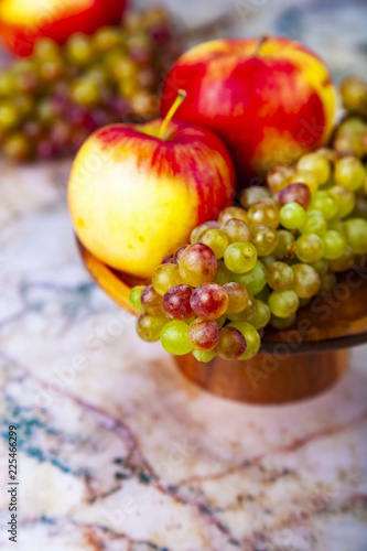 Grapes and apples in a wooden bowl