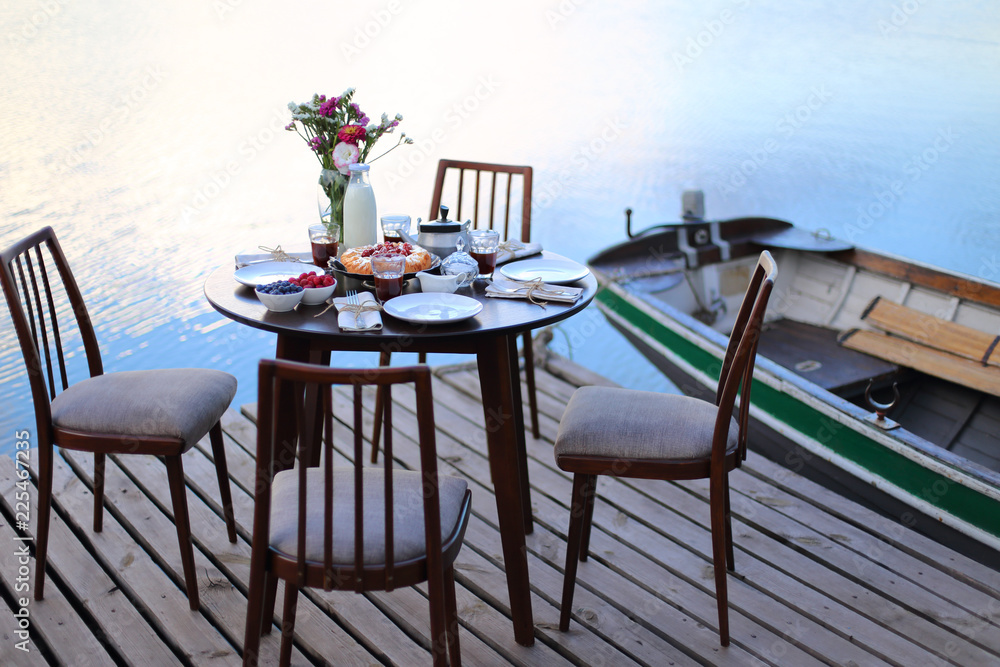 Fototapeta premium Table served for party dinner on river pier