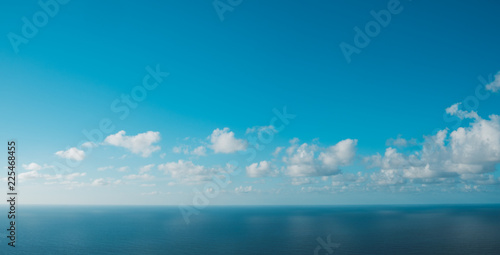  blue sky above ocean horizon with clouds