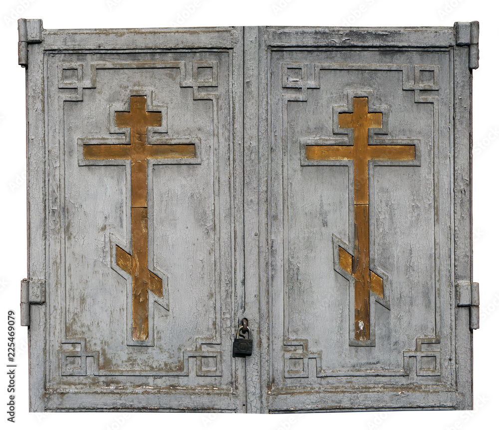 Fragment of locked wooden gates of the old historical church with golden Christian crosses.