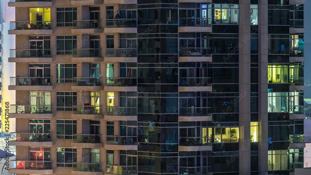 Glowing windows of skyscrapers at evening timelapse