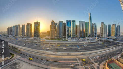 Aerial view of Jumeirah lakes towers skyscrapers at sunrise timelapse with traffic on sheikh zayed road.