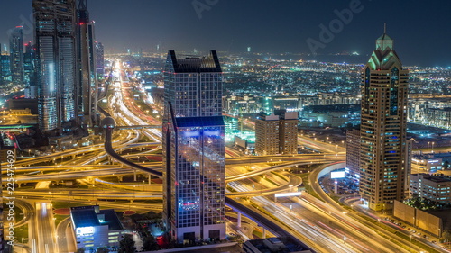 Night traffic on a busy intersection on Sheikh Zayed highway aerial timelapse