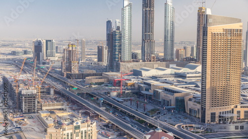 Dubai downtown skyline at sunset timelapse and road traffic near mall, UAE