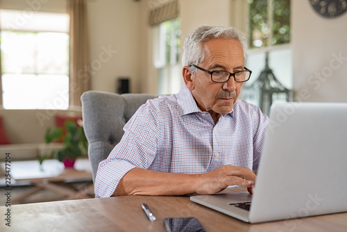 Senior man using laptop