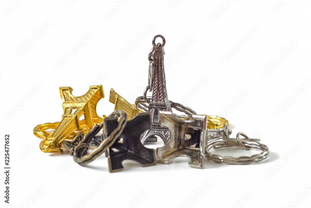 Several traditional French key fobs in the shape of the Eiffel tower isolated on a white background Several traditional French key fobs in the shape of the Eiffel tower isolated on a white background