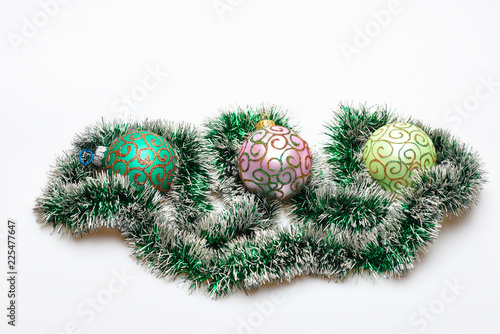 Christmas tinsel with ornaments or decoration on white background. Tinsel and balls with glitter and shimmering decorative ornaments. Christmas decoration concept © be free