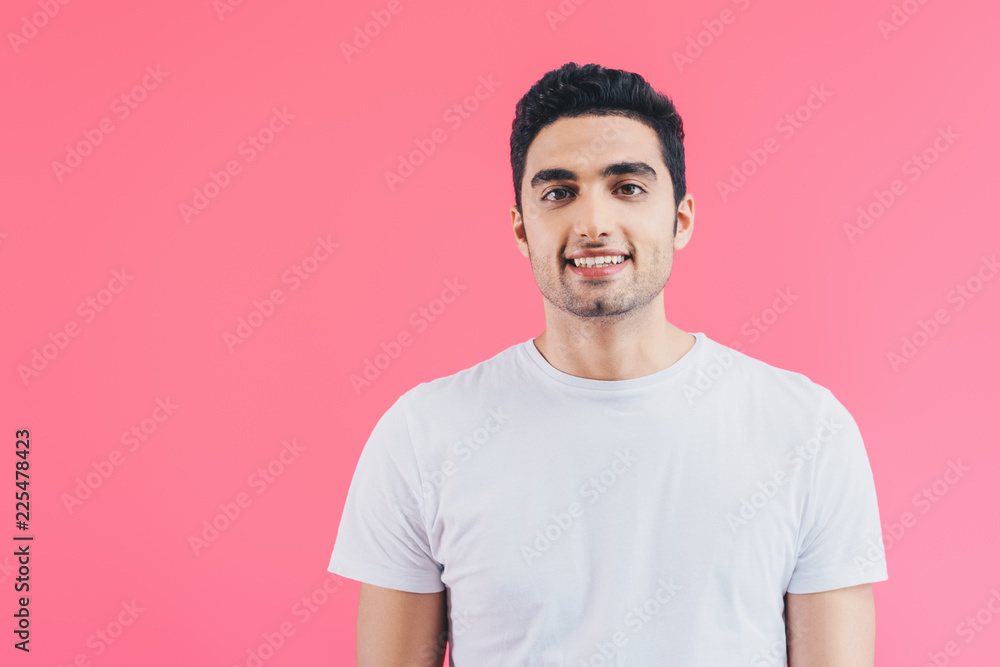 portrait of smiling handsome man looking at camera isolated on pink portrait of smiling handsome man looking at camera isolated on pink