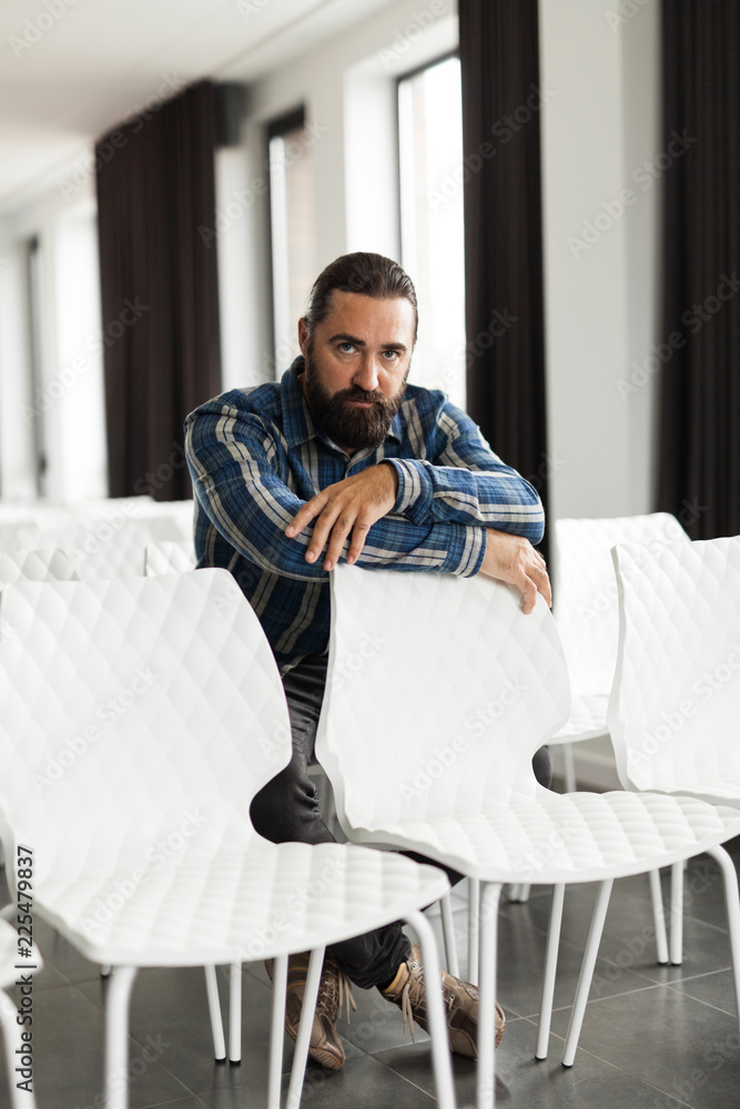 Relaxed handsome beard man, sitting on chair. Relaxed handsome beard man, sitting on chair.