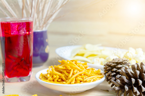 Relax time with juice and snacks on wooden table.