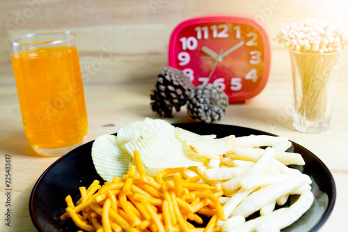 Relax time with juice and snacks on wooden table.