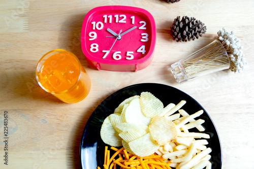 Relax time with juice and snacks on wooden table.