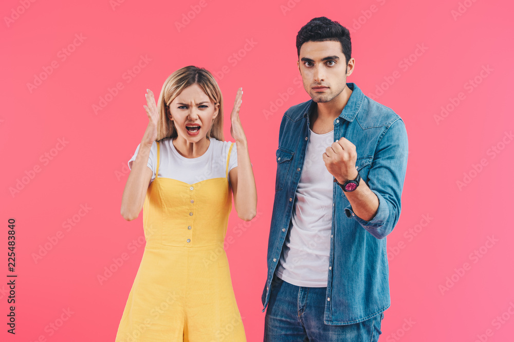 angry yelling woman gesturing by hands and her boyfriend threatening by fist isolated on pink angry yelling woman gesturing by hands and her boyfriend threatening by fist isolated on pink
