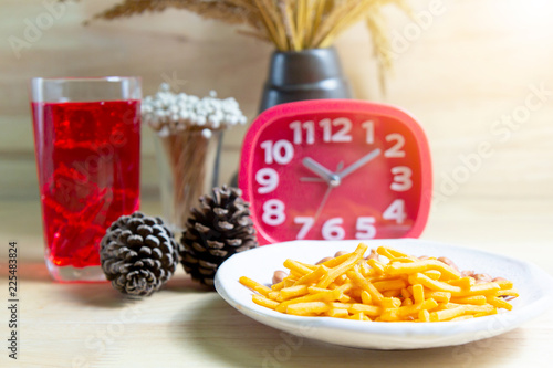 Relax time with juice and snacks on wooden table.