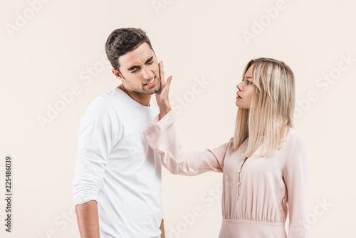 young couple quarreling isolated on beige, Relationship problems concept