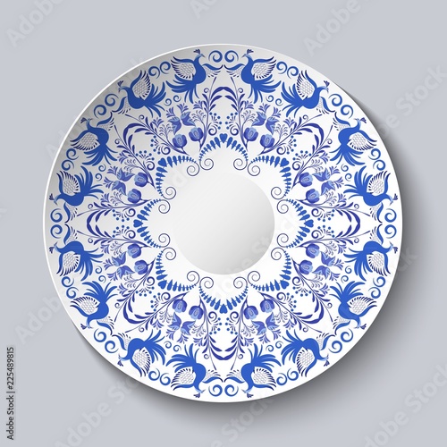 Decorative plate with a blue ornament of birds and flowers. Template design in ethnic style Gzhel porcelain painting.