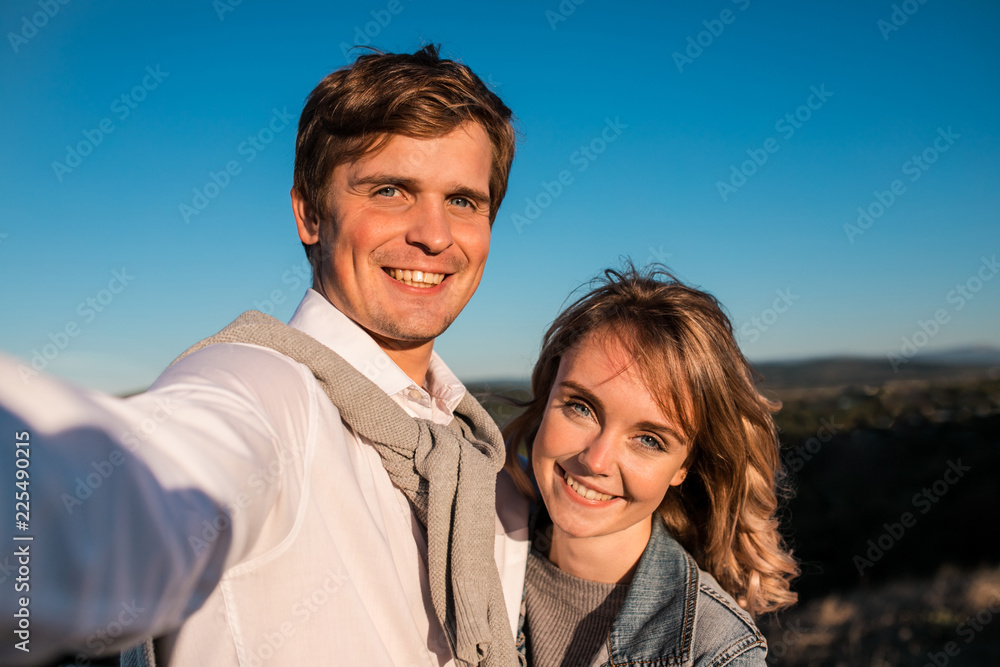 Happy young cute couple making selfie outdoors Happy young cute couple making selfie outdoors