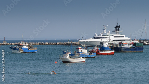 Fishing boats and luxury yacht docked at Cascais marina, near Lisbon, Portugal © Alexandre Rotenberg