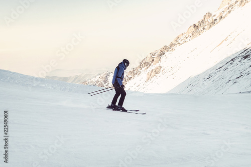 Obraz na plátně Skier skiing downhill in high mountains