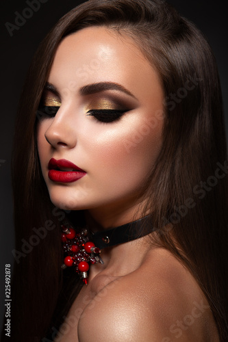 Beauty Model Woman with Long Brown Hair. Healthy Hair and Beautiful Professional Makeup. Red Lips and Smoky Eyes Make up. Gorgeous Glamour Lady Portrait. Haircare, Skincare concept