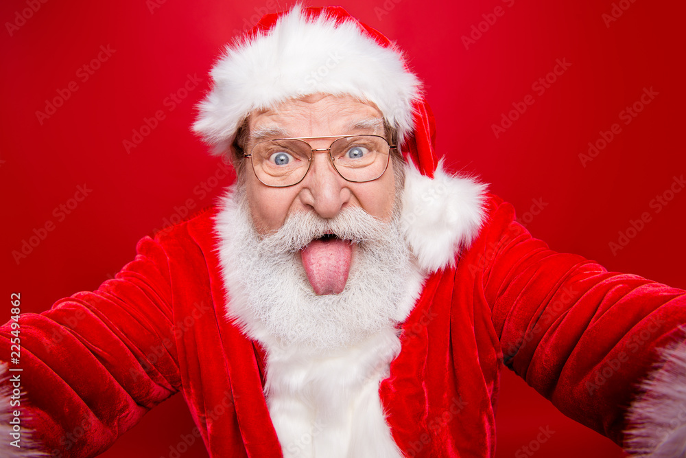 Close up aged face playful funky stylish grandfather Santa fooli Close up aged face playful funky stylish grandfather Santa fooli