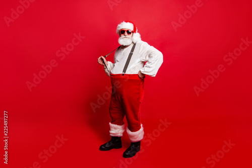 Full length body size of nice calm peaceful Santa pulling suspen