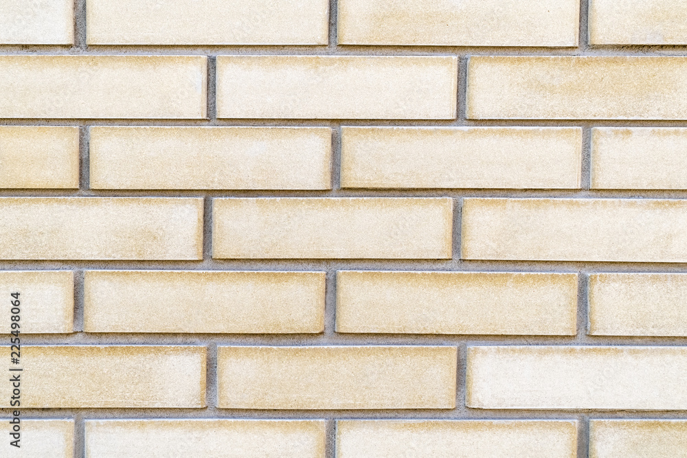 Texture beige with a yellow decorative brick as background