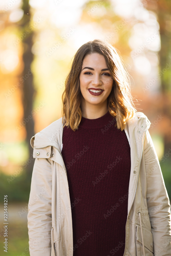 Beautiful and stylish young woman in sweater outdoors Beautiful and stylish young woman in sweater outdoors