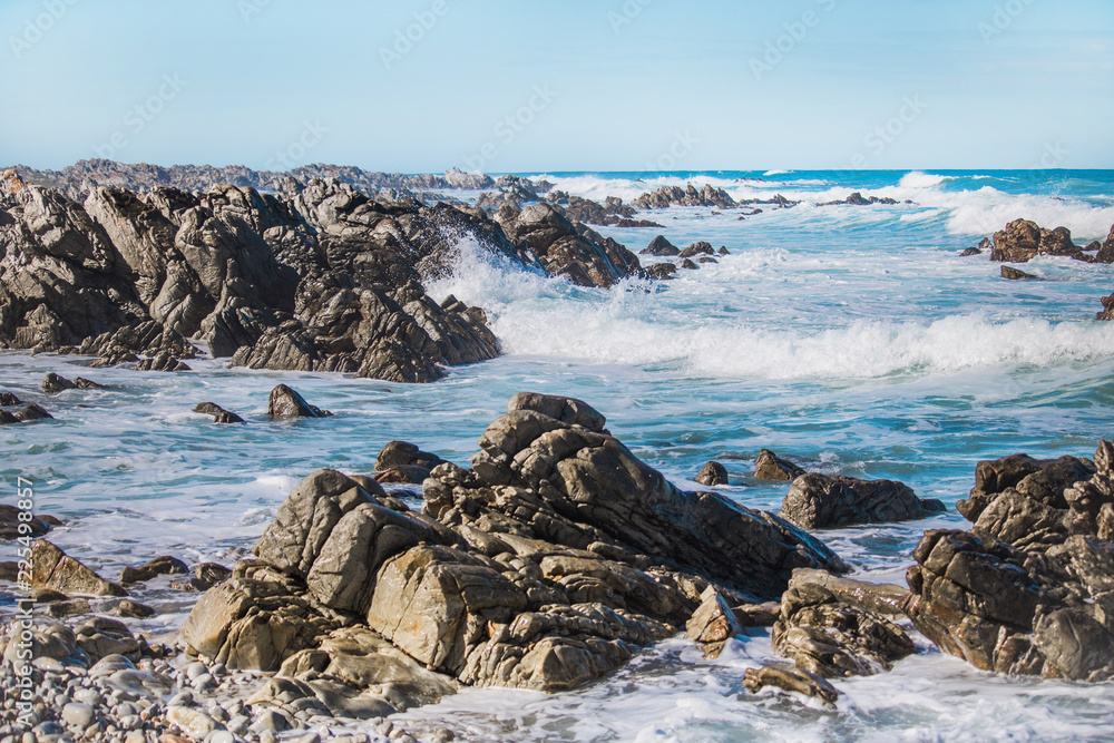 Crashing waves hitting rocks on the shore. Crashing waves hitting rocks on the shore.