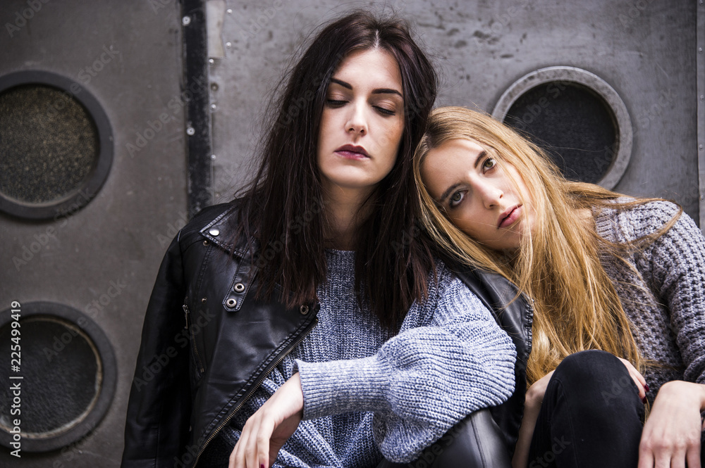 Nice young hipster models are sitting and posing on the street. Fashion conception. Nice young hipster models are sitting and posing on the street. Fashion conception.