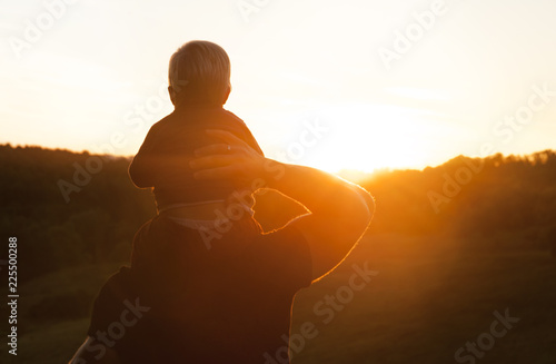 Father and son watching the sunset outdoors in the autumn evening ©  Даниил Дудник