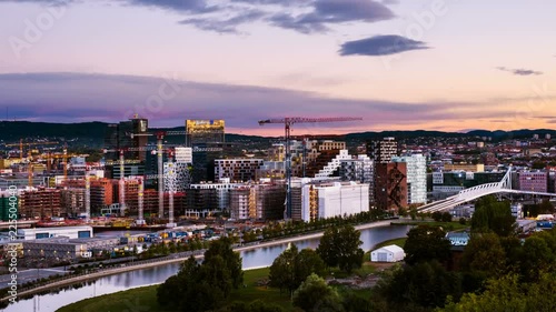 Oslo, Norway. A sunrise view of Sentrum area of Oslo, Norway, with Barcode buildings and the river Akerselva. Construction site with sunrise colorful sky. Time-lapse photo