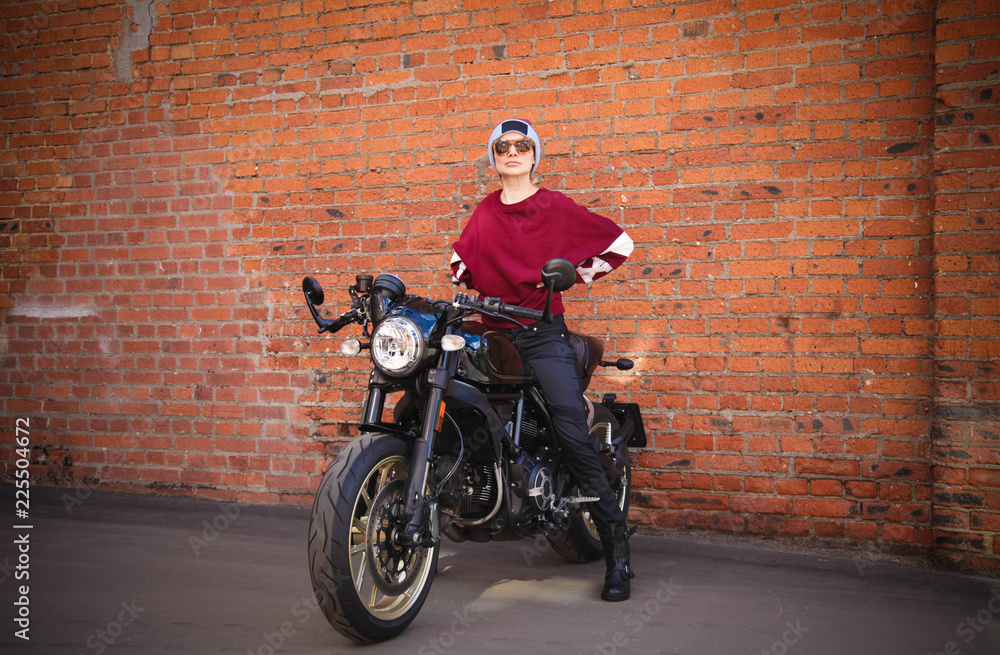 Woman and retro cafe racer motorcycle
