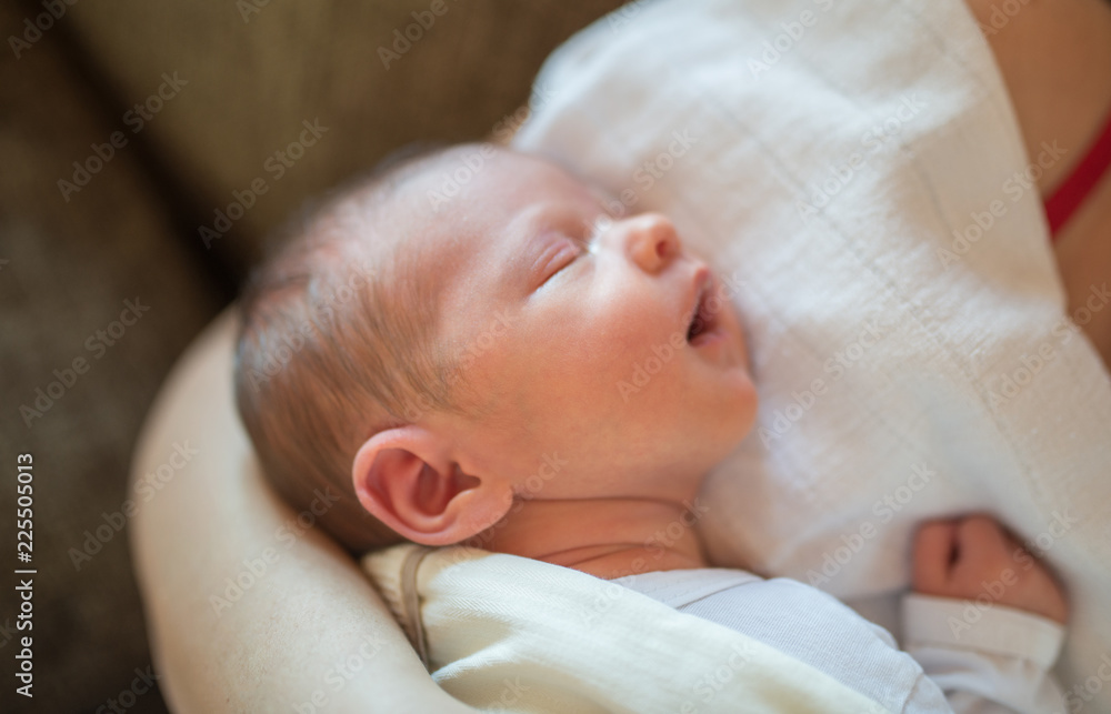 Peaceful baby lying on mum arms Peaceful baby lying on mum arms