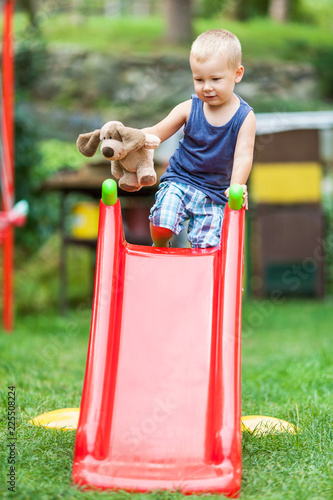 Adorable child playing on the slide
