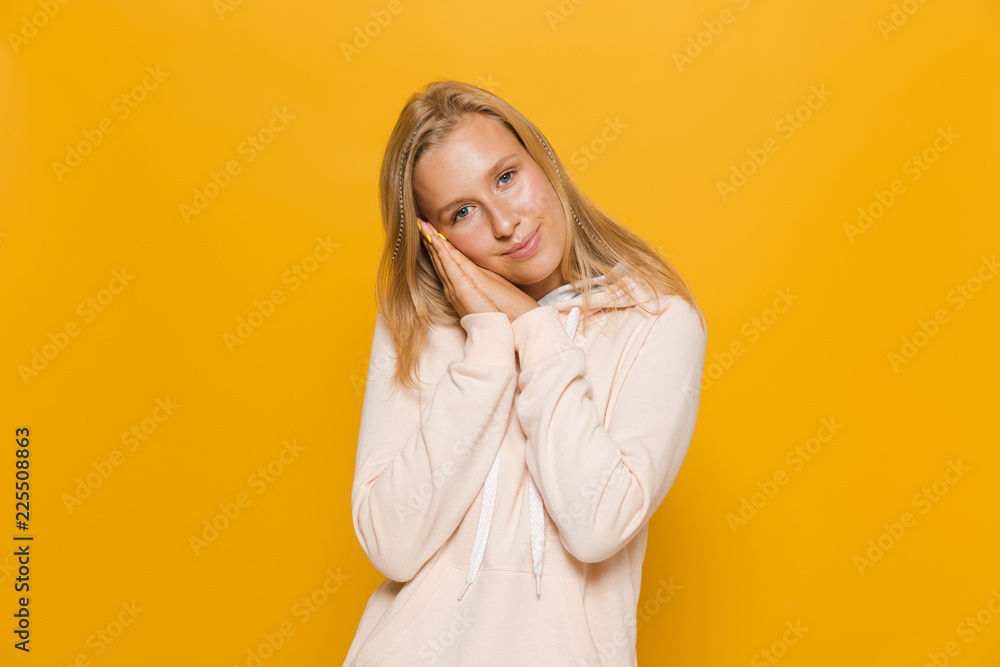 Photo of cheerful girl 16-18 with dental braces smiling at camera, isolated over yellow background Photo of cheerful girl 16-18 with dental braces smiling at camera, isolated over yellow background
